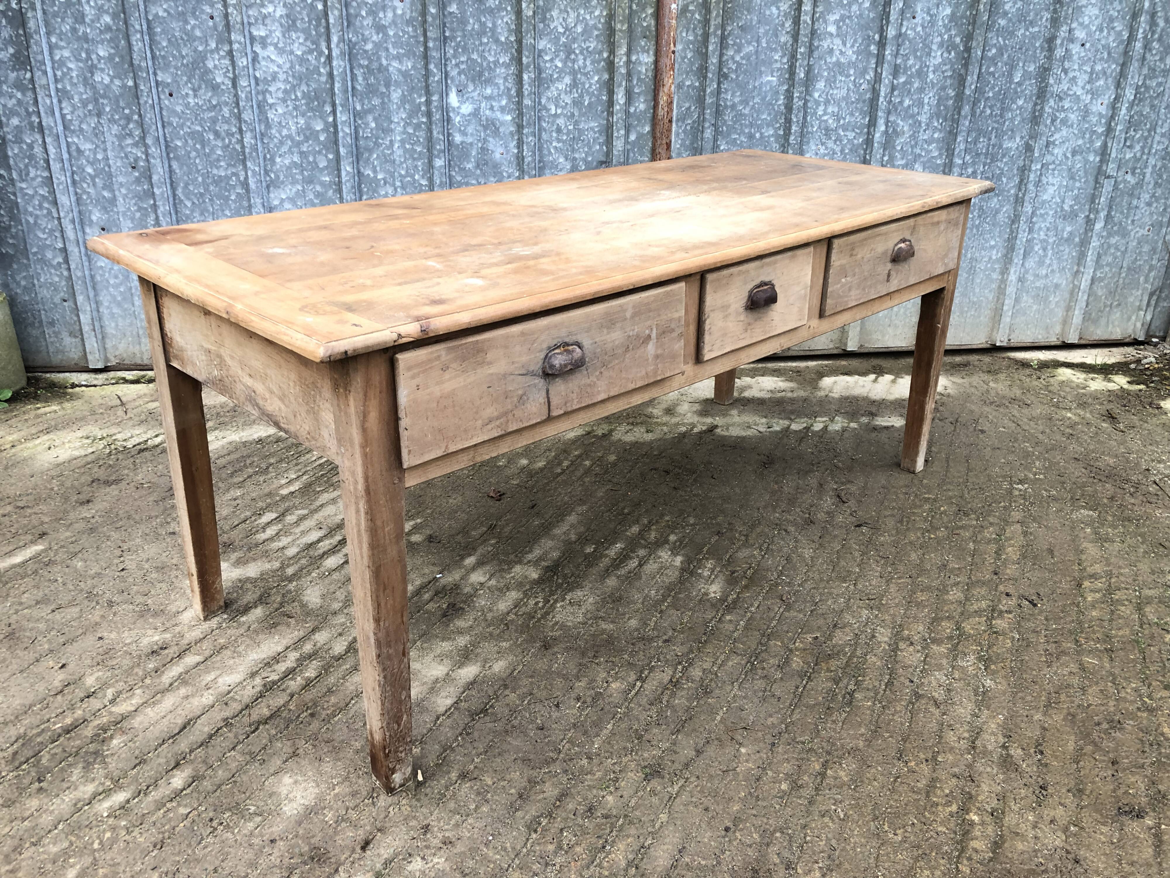 Antique solid cherry farm table with 3 front drawers.