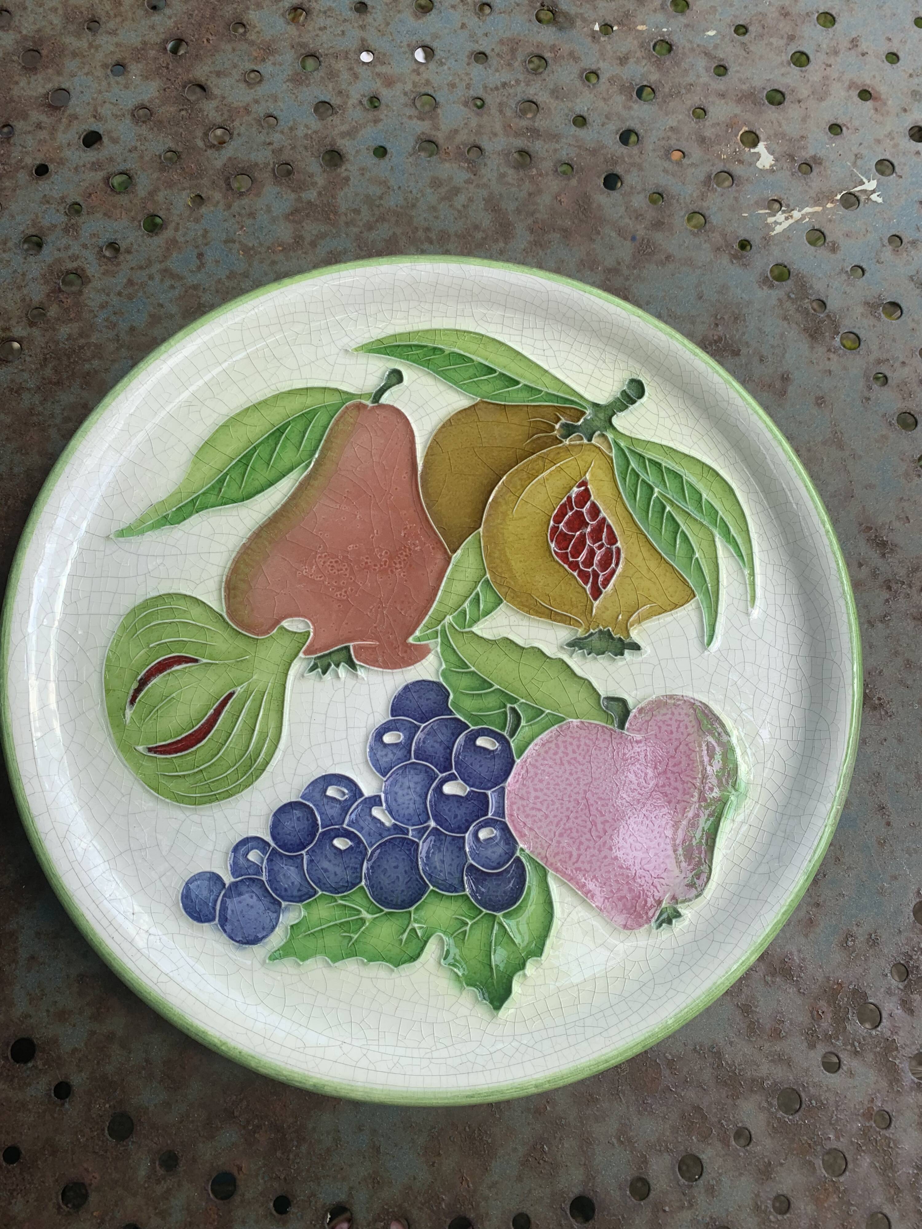 Decorative plate to hang, fruit model, in enamelled ceramic, Les Fruits, signed Luciano