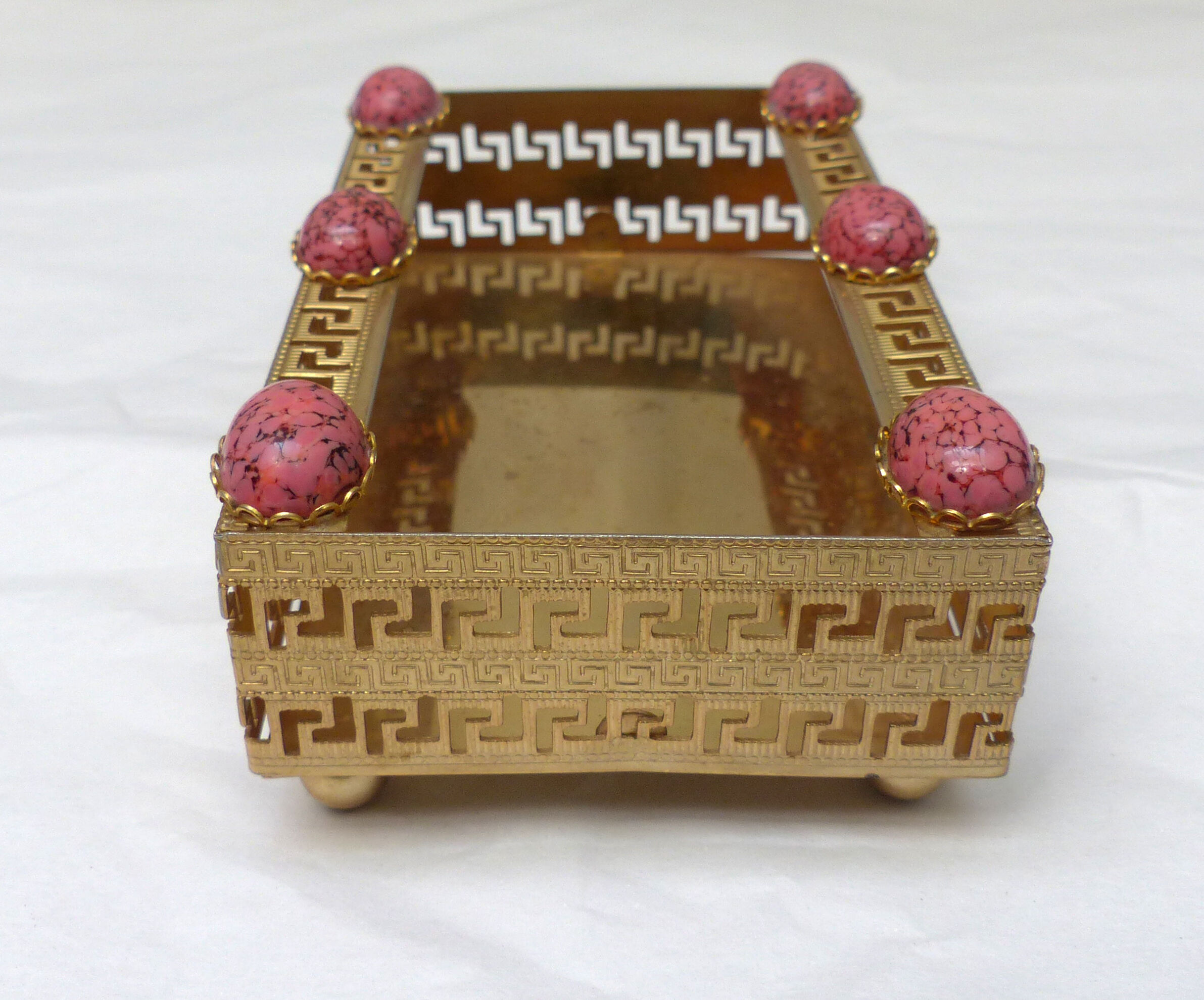 Golden metal catchall with pink stones