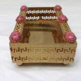 Empty pocket in gold metal and pink stones