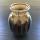 Brown and black flame-colored vase