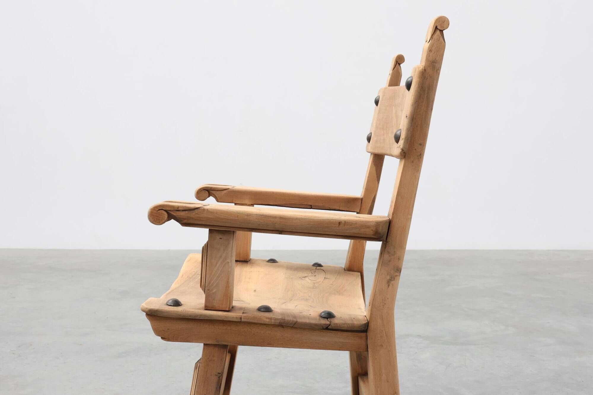 Brutalist armchair with carved rosettes and nailed wooden seat, Spain