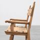 Brutalist armchair with carved rosettes and nailed wooden seat, Spain