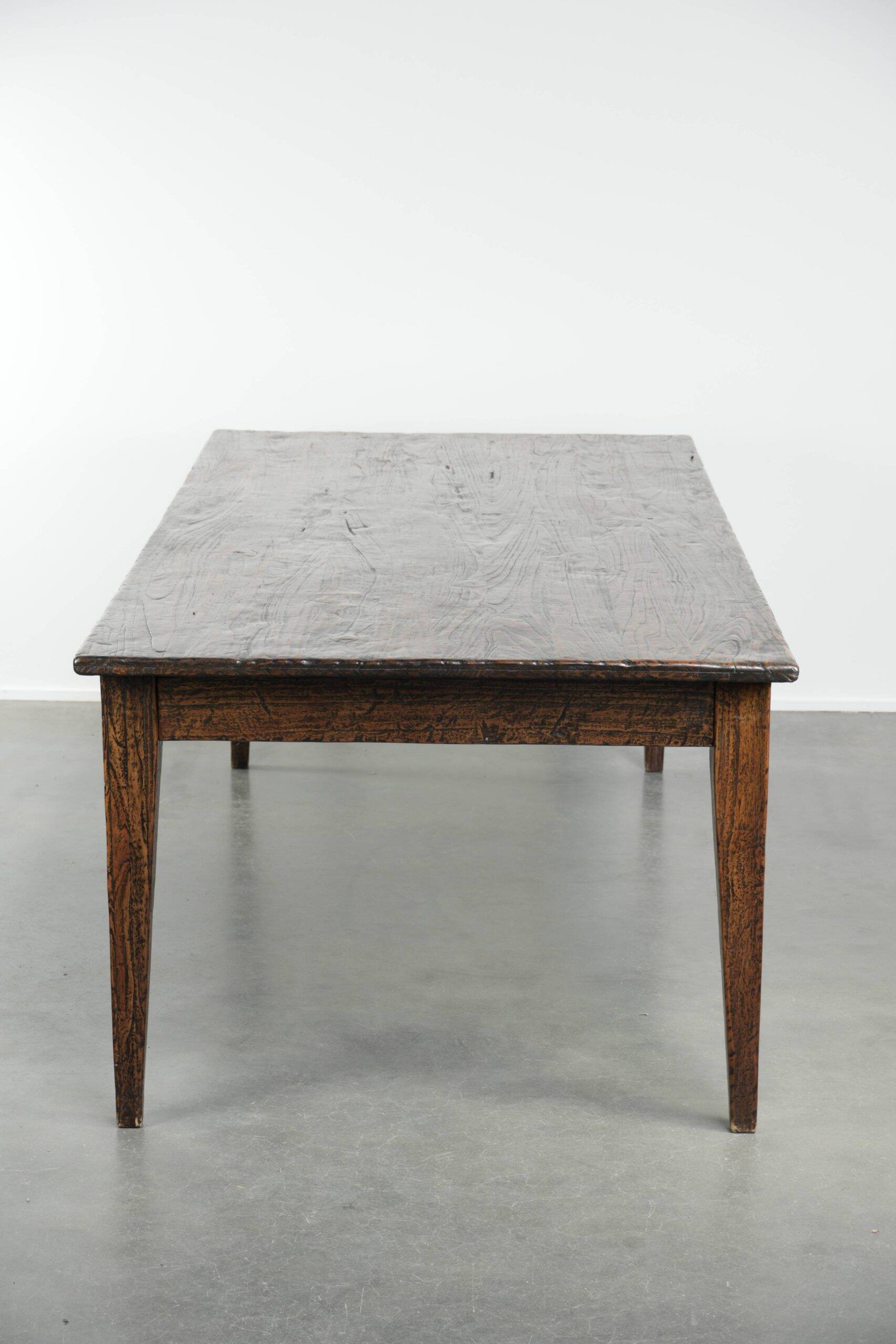 Large rustic dining table made of atmospheric elm wood with fine details