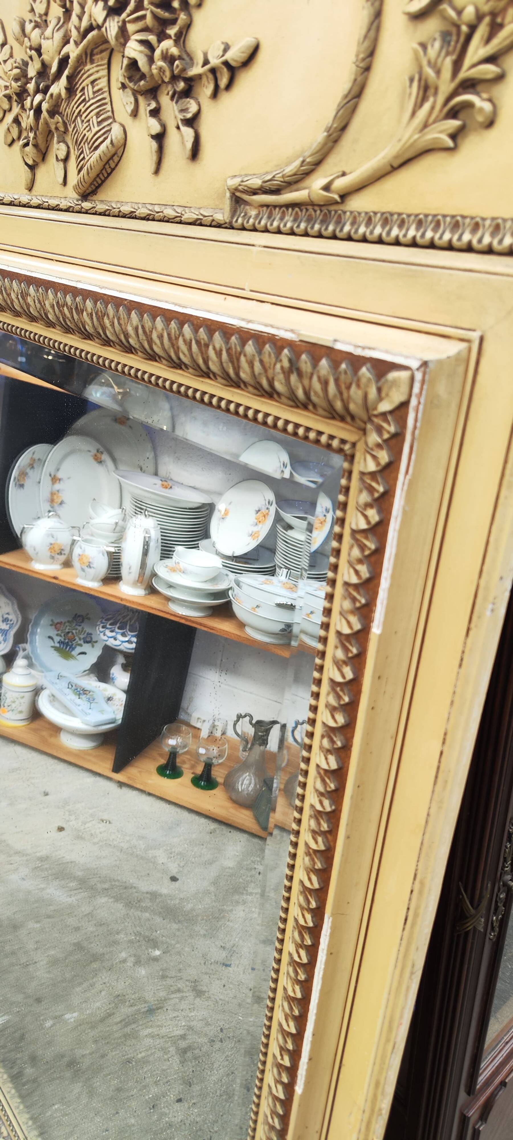 Old large Louis XVI style trumeau mirror with pediment and floral basket knot