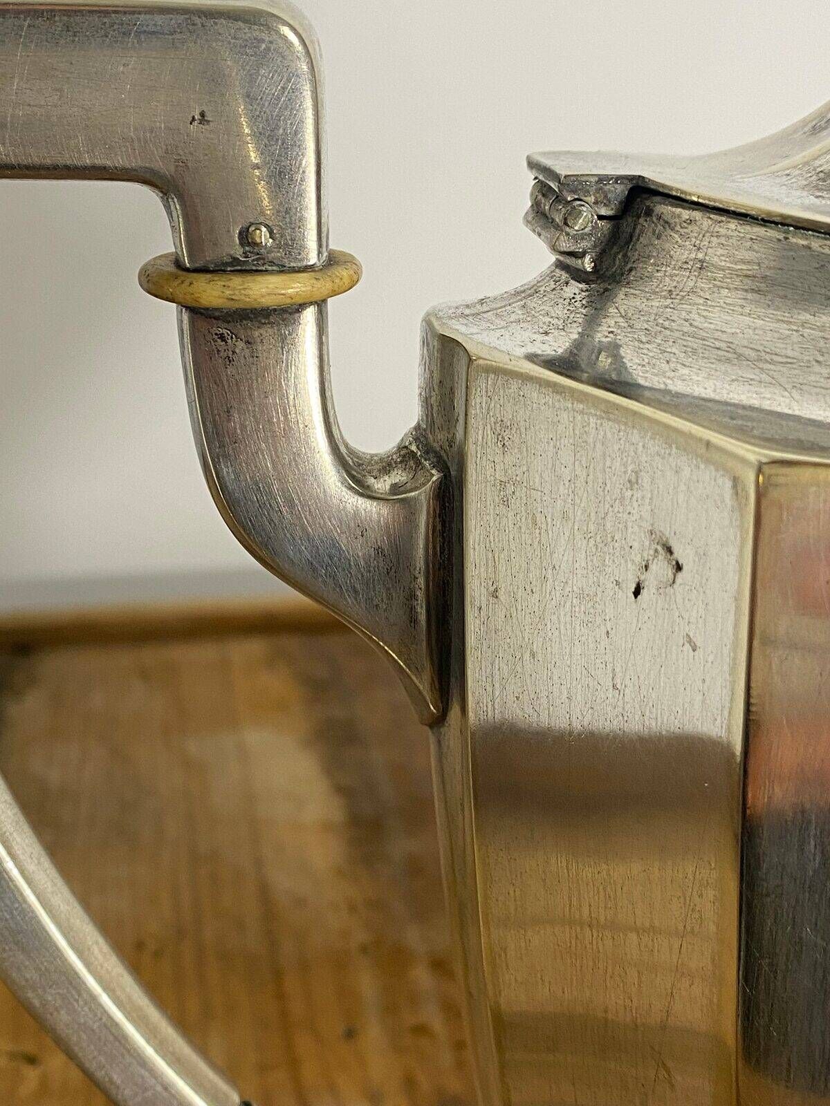 Art Deco silver-plated teapot with faceted decoration.