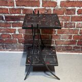 Black metal server and earthenware tiles with geometric patterns