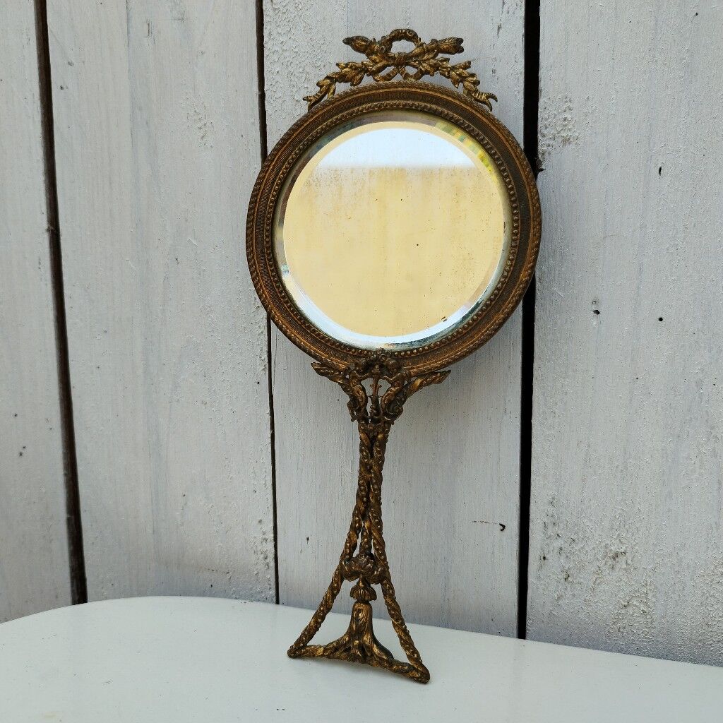 Mirror face to hand gilded bronze knot ribbon