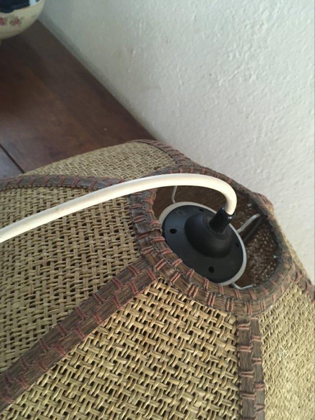 Two-tone flower hanging in braided straw.