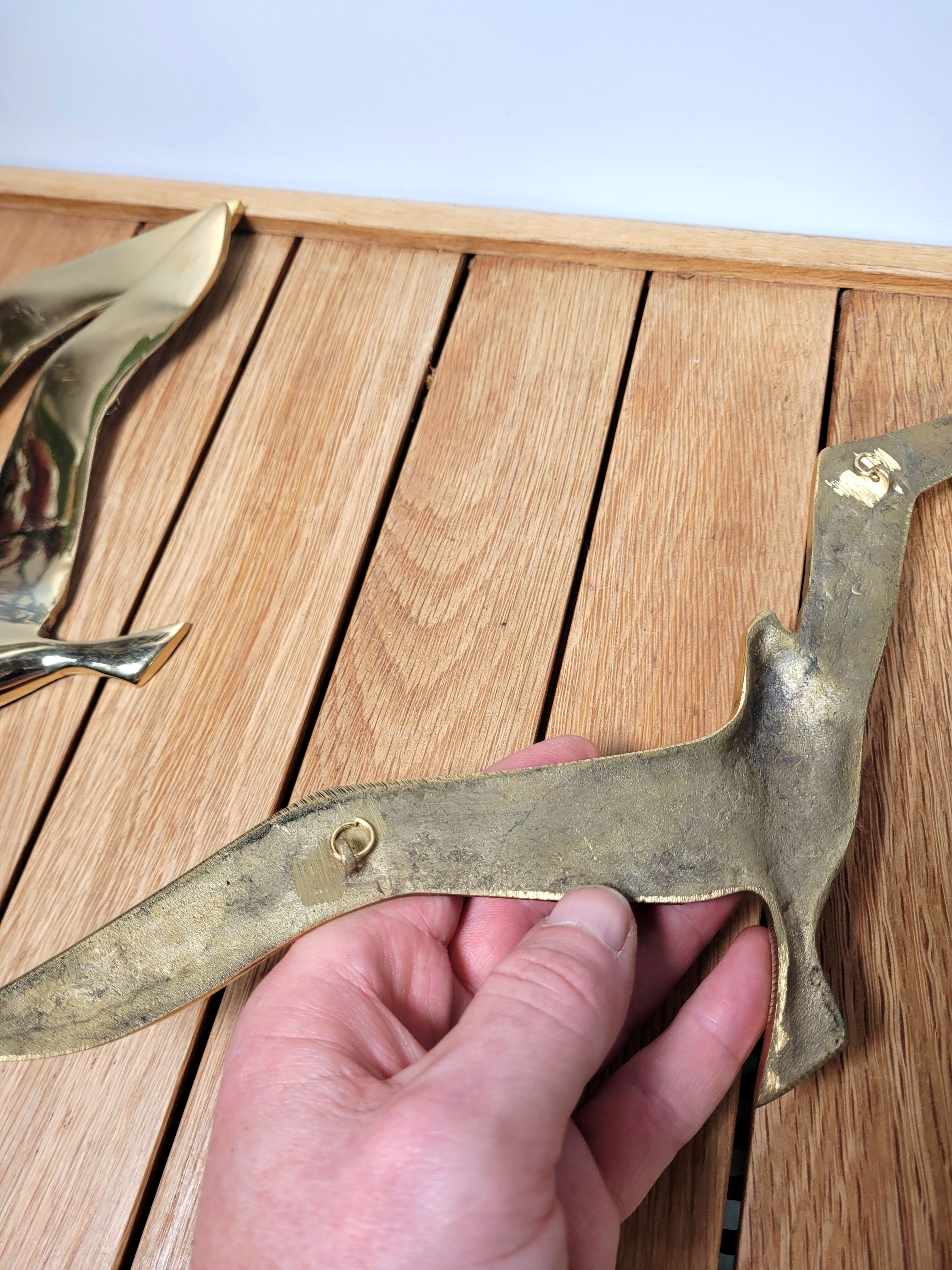 Flight of 3 gulls or brass swallows