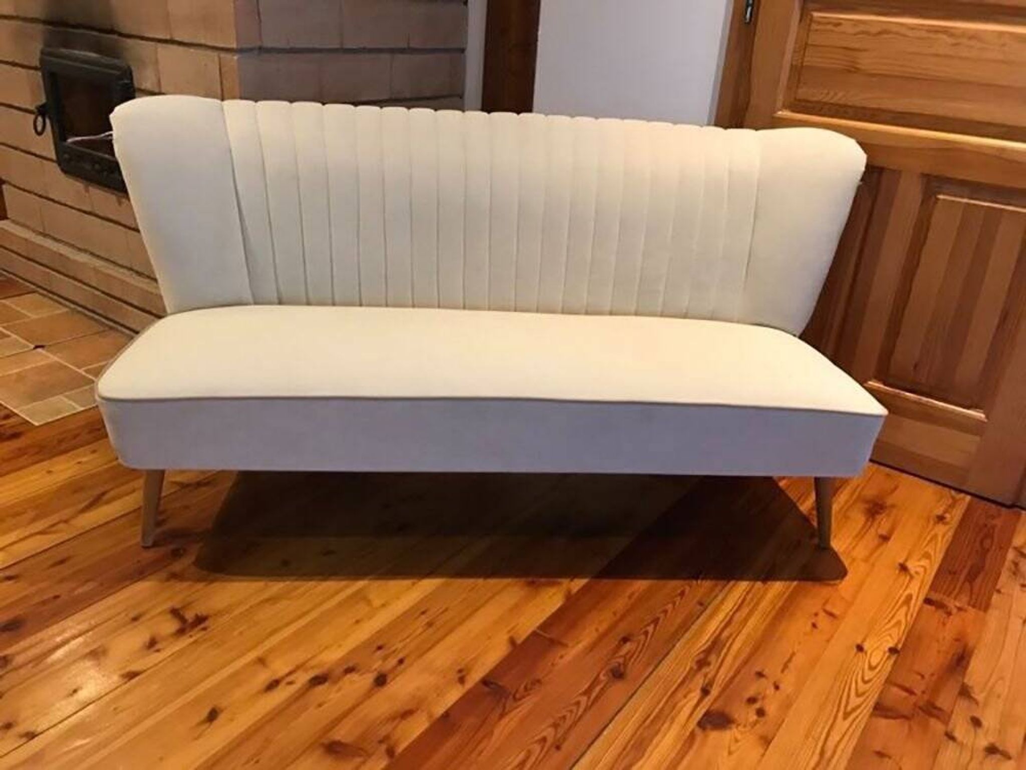 Mid-Century 1950s style two-seater canapé with cream fabric and solid beech.