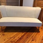 Mid-Century 1950s style two-seater canapé with cream fabric and solid beech.