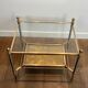 Pair of neoclassical side tables in steel and brass by Maison Jansen.