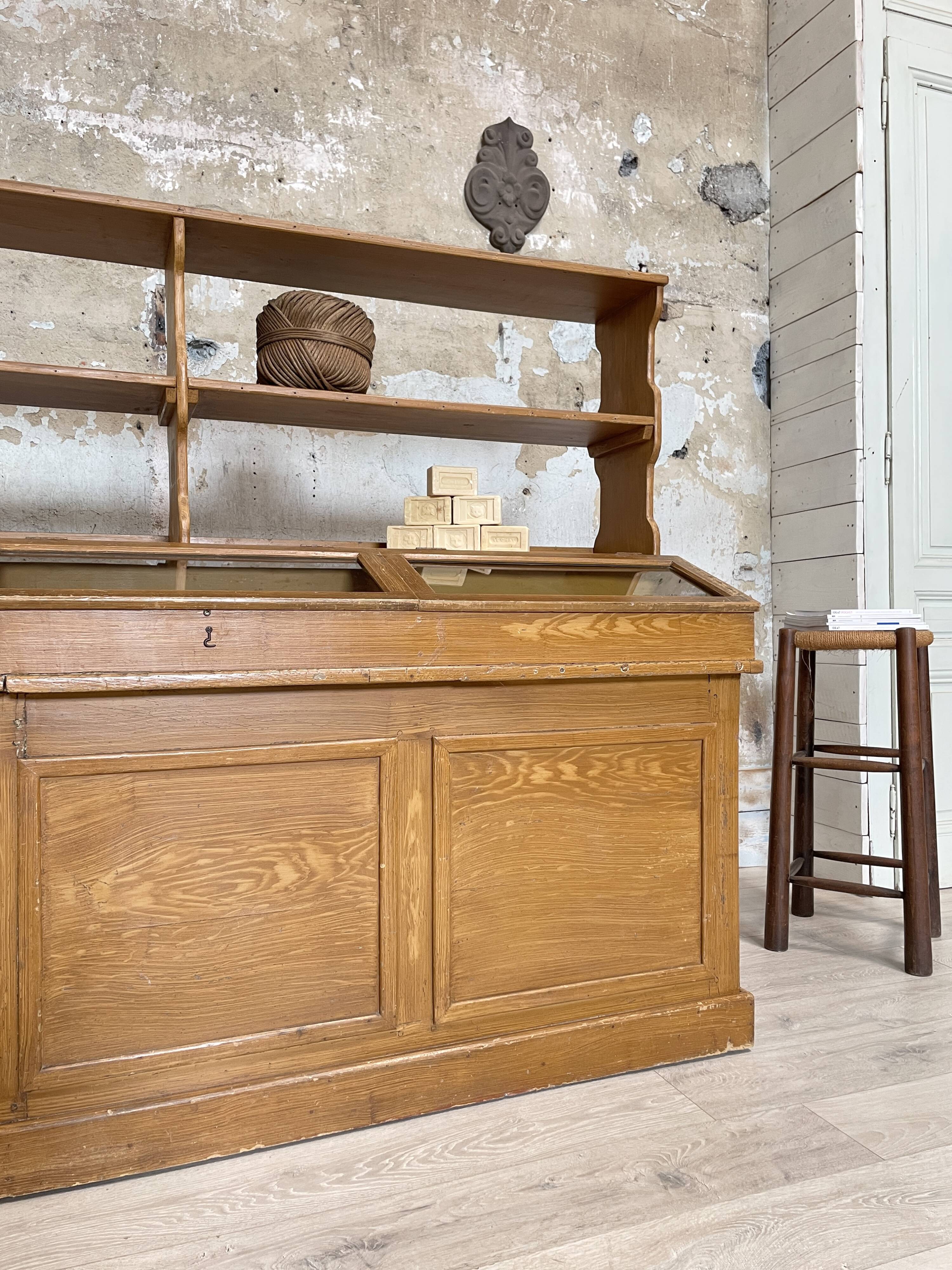 Wooden hardware cabinet painted with wood effect, circa 1940.