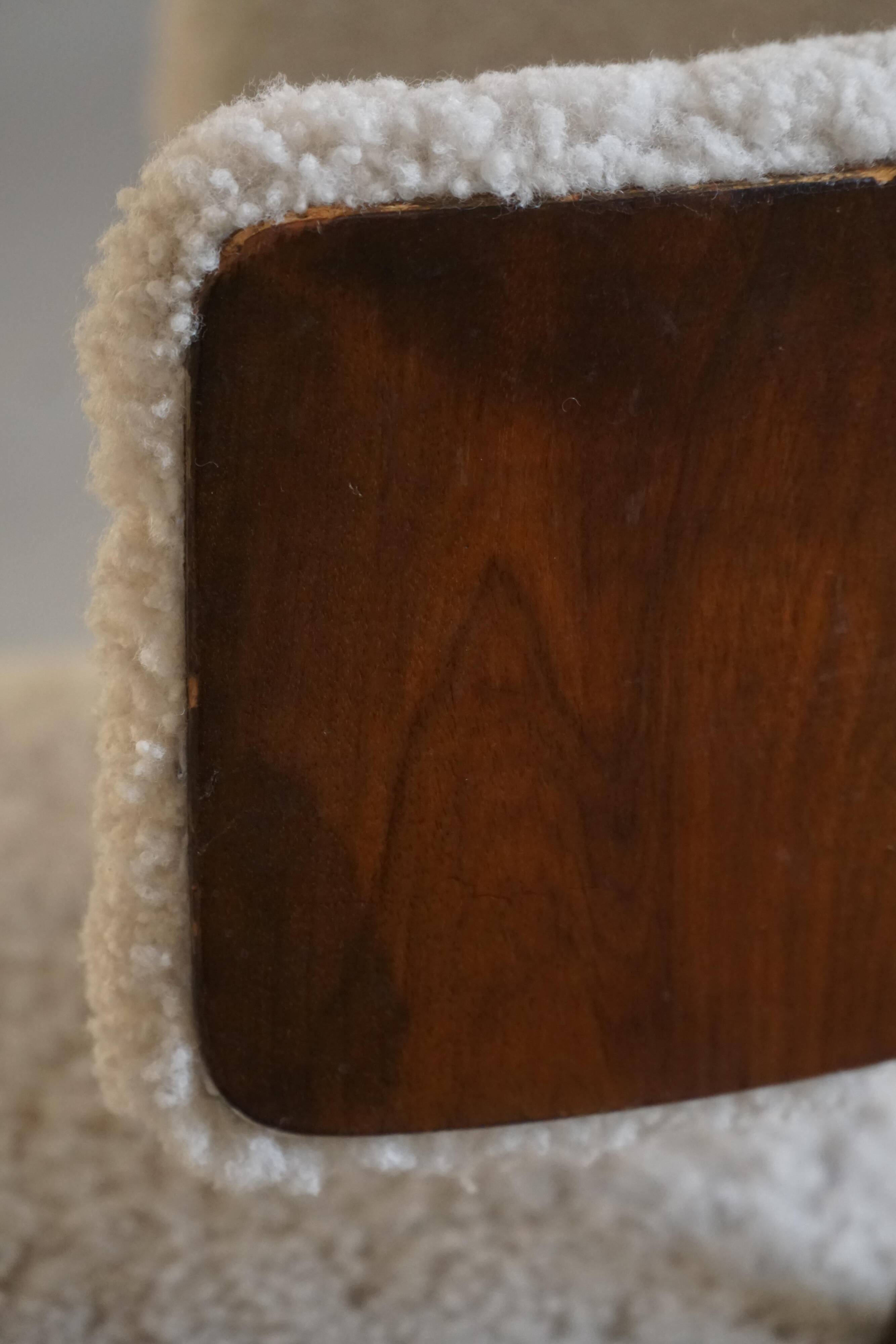 A modern Danish elegant low-back chair, reupholstered in lambswool, 1940s.