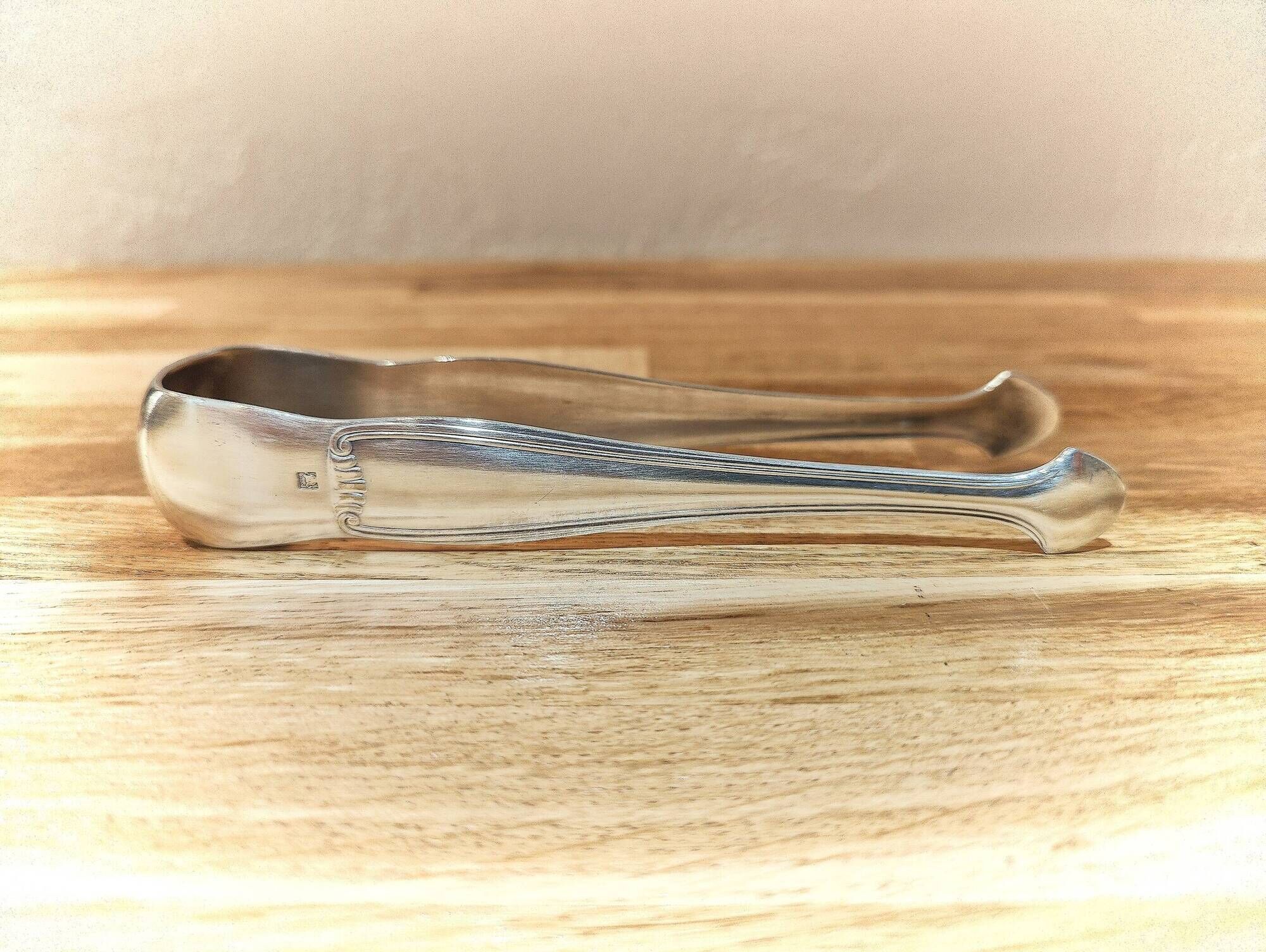 Antique sugar tongs in silvered metal