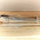 Antique sugar tongs in silvered metal