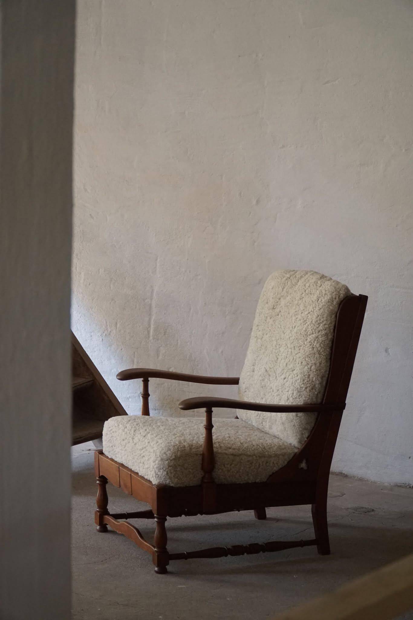 Modern Danish design, a pair of high-backed armchairs in oak and lambswool, 1950s.