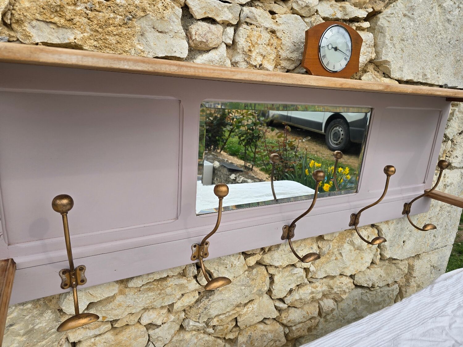 Coat rack or wall-mounted entrance wardrobe with scroll arms and antique hooks.