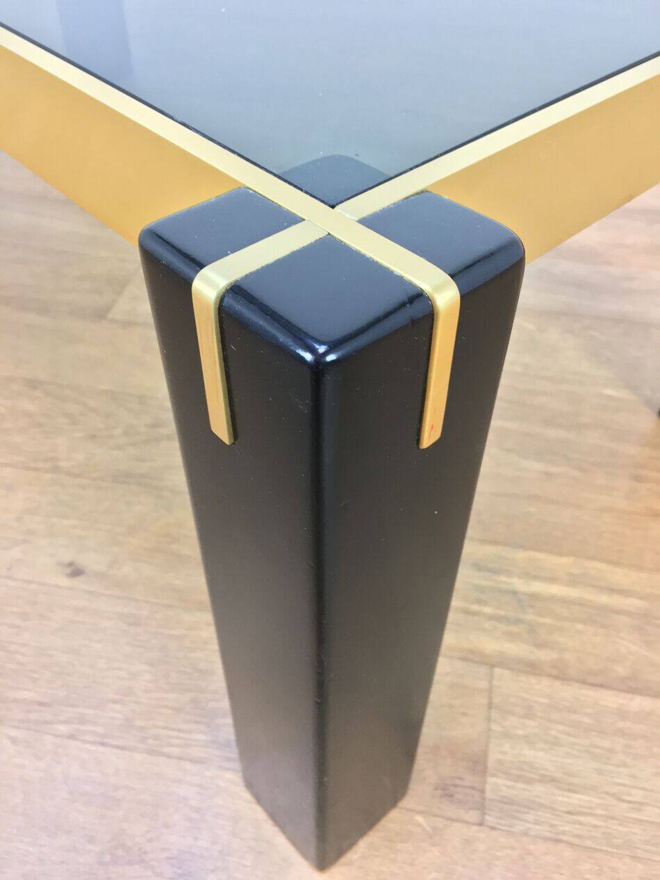 Italian coffee table from the 70s, smoked glass, black and gold lacquered wood.