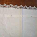 Ancient monogrammed pillowcase adorned with cotton lace