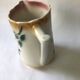 Antique barbotine pitcher with floral decoration numbered 548