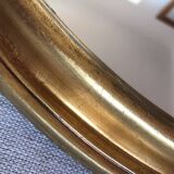 Golden oval mirror