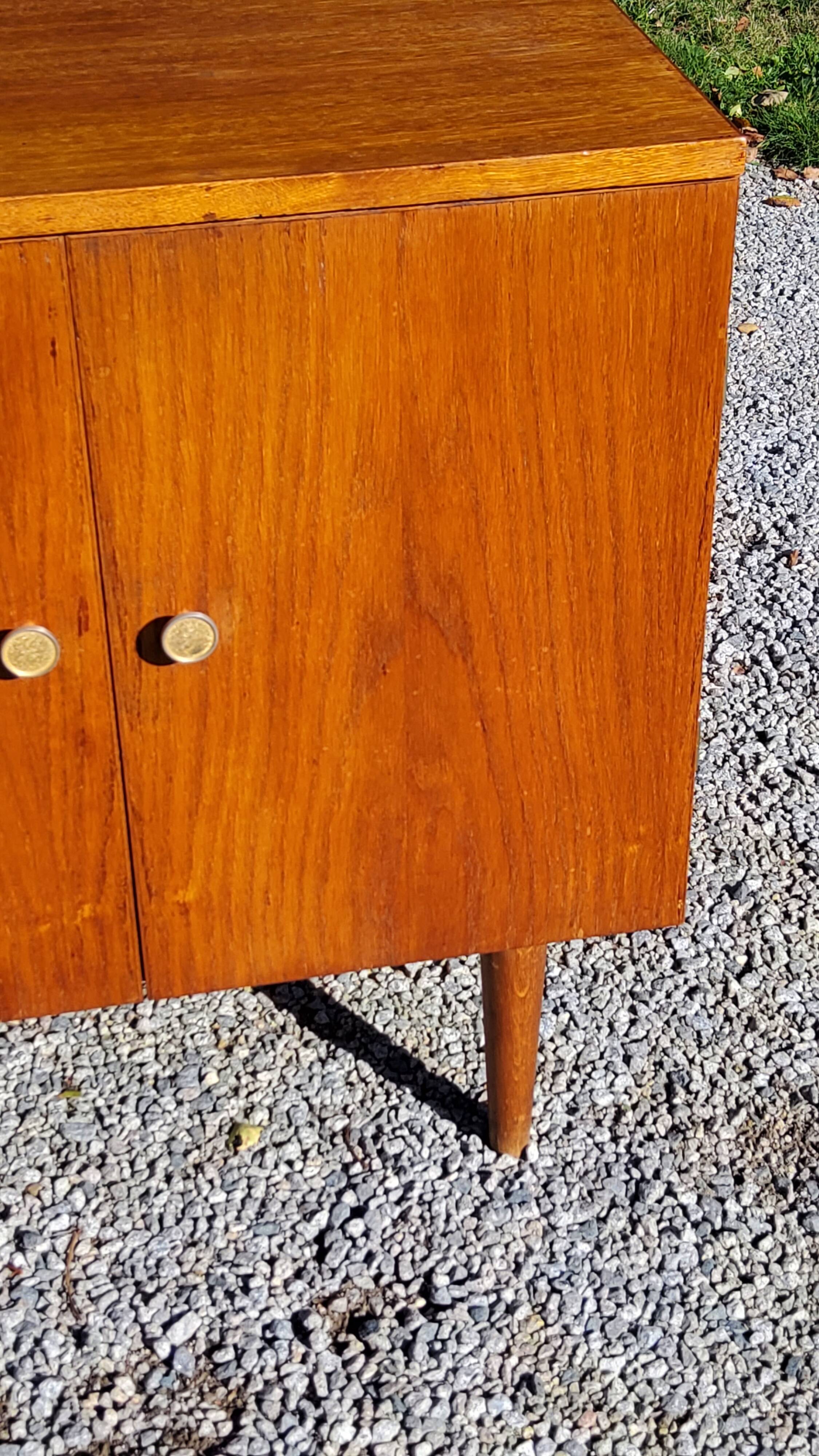 Vintage golden oak sideboard with conical legs from the 1950s