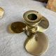Pair of vintage brass propeller-shaped candlesticks