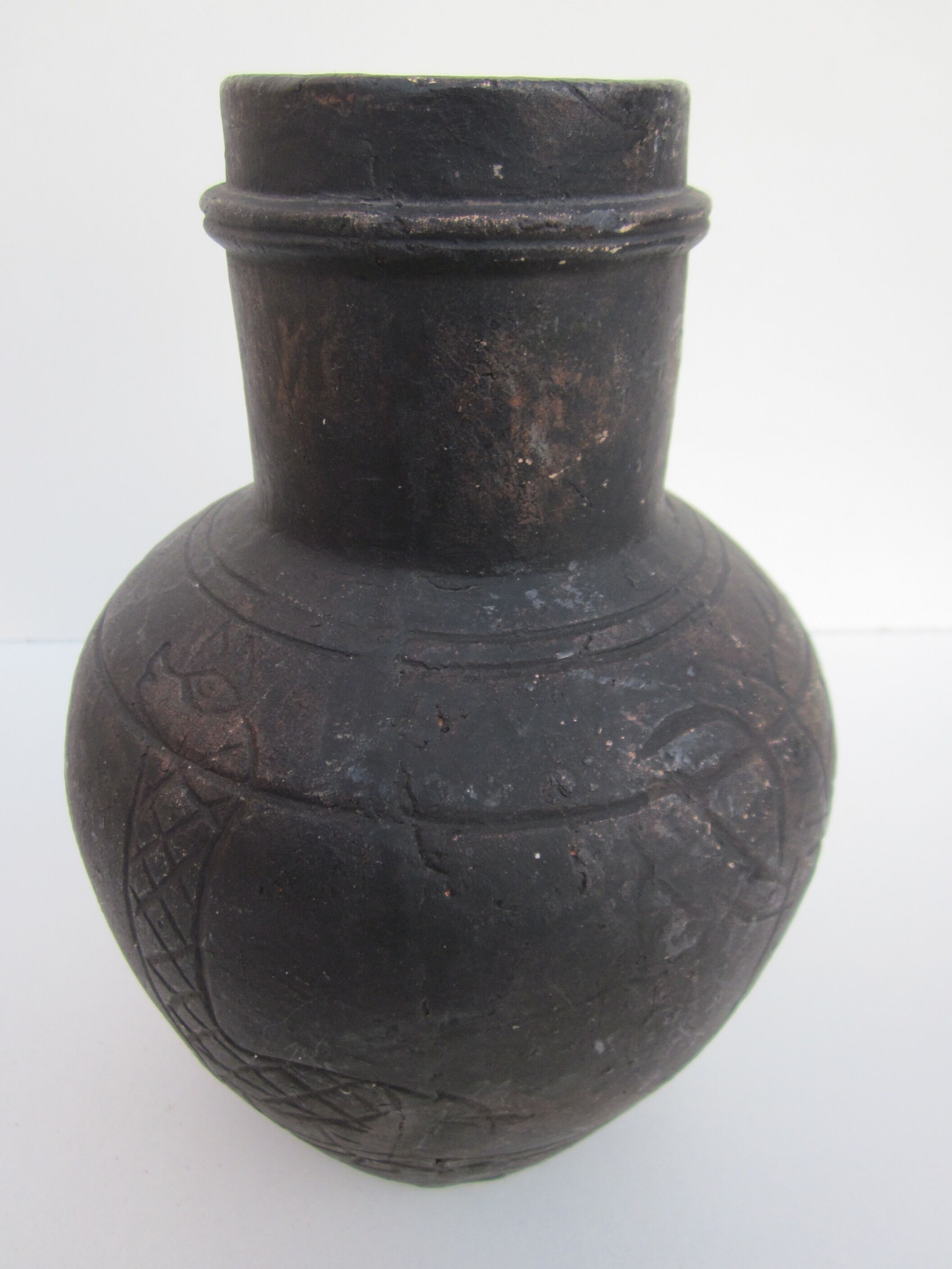 Black African pottery with stylized giraffe pattern