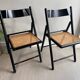 Vintage folding chairs in black wood and cane.