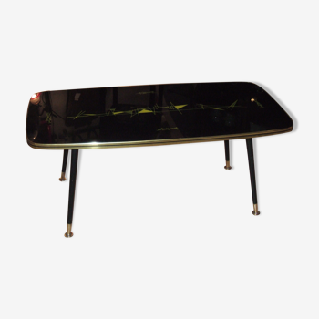 Table basse à pied compas 1960, plateau à décoration abstraite sous verre.