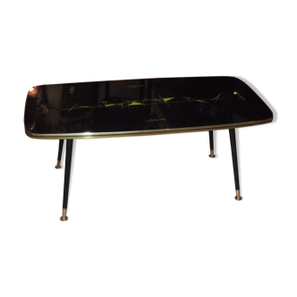 Table basse à pied compas 1960, plateau à décoration abstraite sous verre.