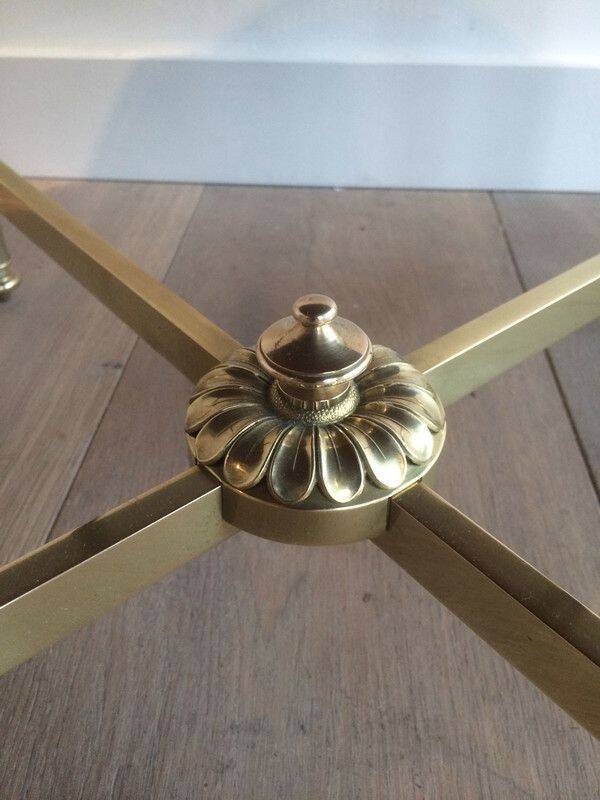 Round coffee table in brass with a black lacquered glass top by Maison Jansen.
