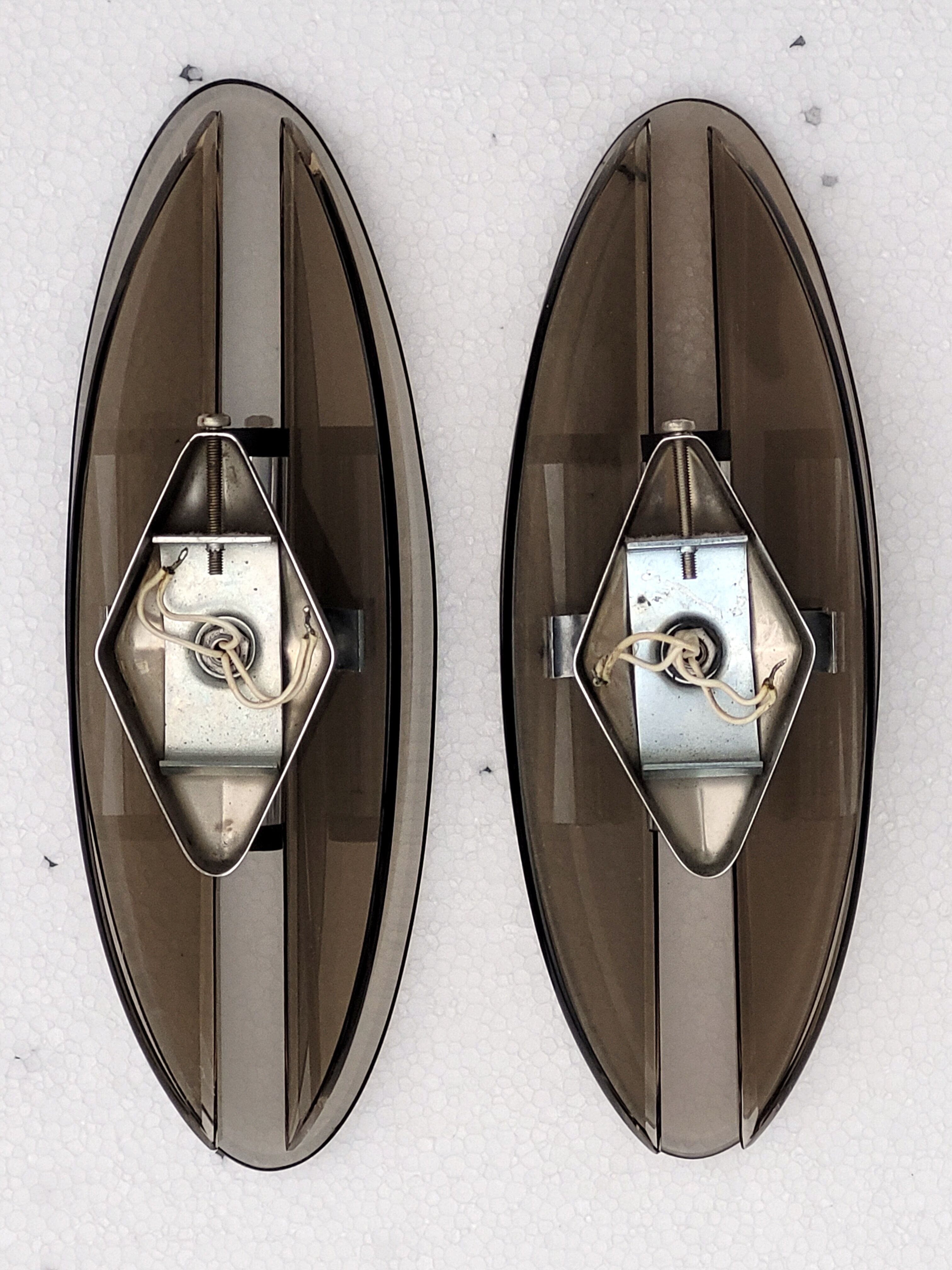 Pair of elliptical italian wall lamps in smoked glass and chrome veca