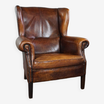 Dark wingback armchair made of sheep leather with stunning colors