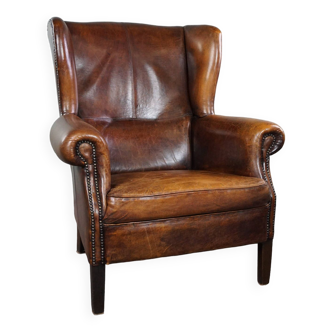 Dark wingback armchair made of sheep leather with stunning colors