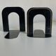 Pair of heavy metal bookends, folded, 1920.