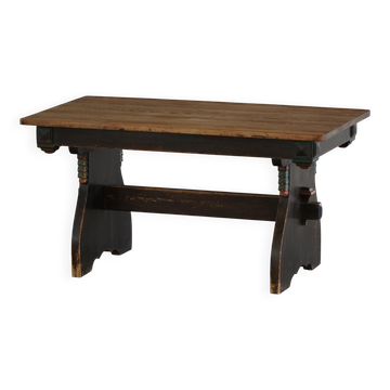 Rustic Scandinavian dining table in stained pine, Sweden, 1900-1940.
