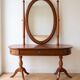 Traditional wooden dressing table with oval mirror.