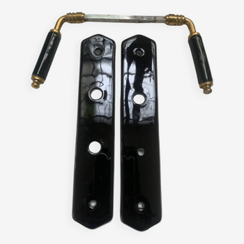 Black porcelain door handle with its clean plate