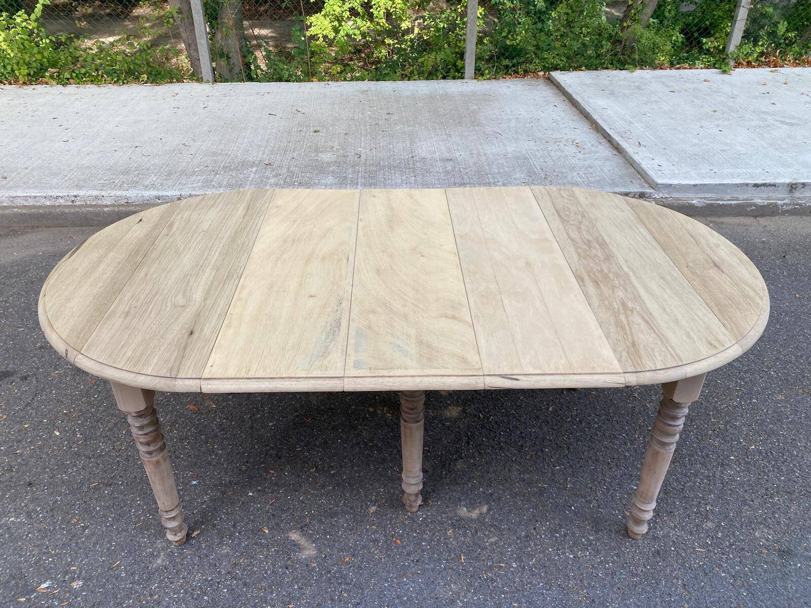 Round extendable dining table with flaps, stripped in raw oak, with 3 extensions.