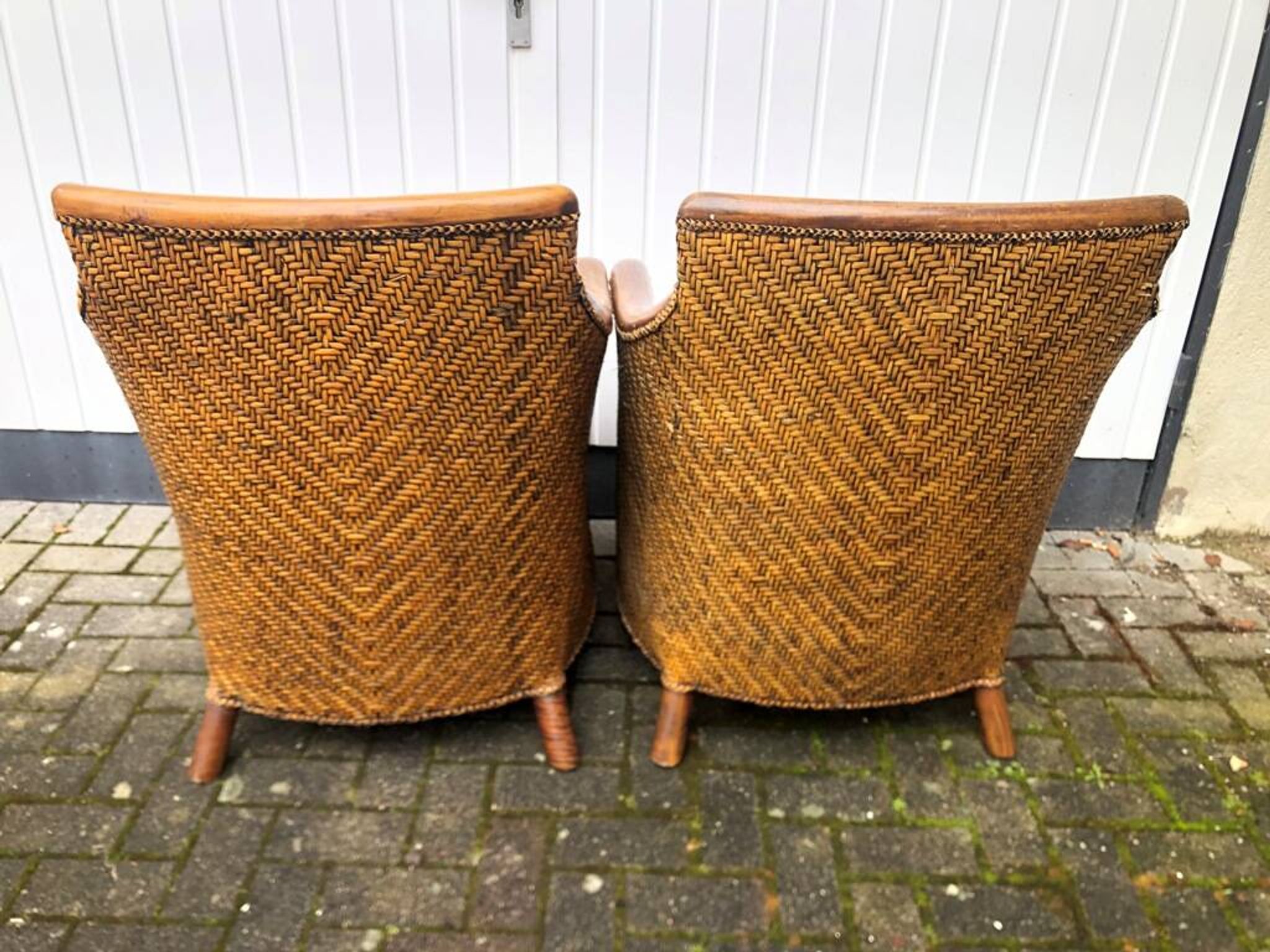 2 colonial armchairs in wood, rattan and leather, 1950s