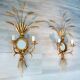A pair of 1950s wall sconces in gold leaf metal.