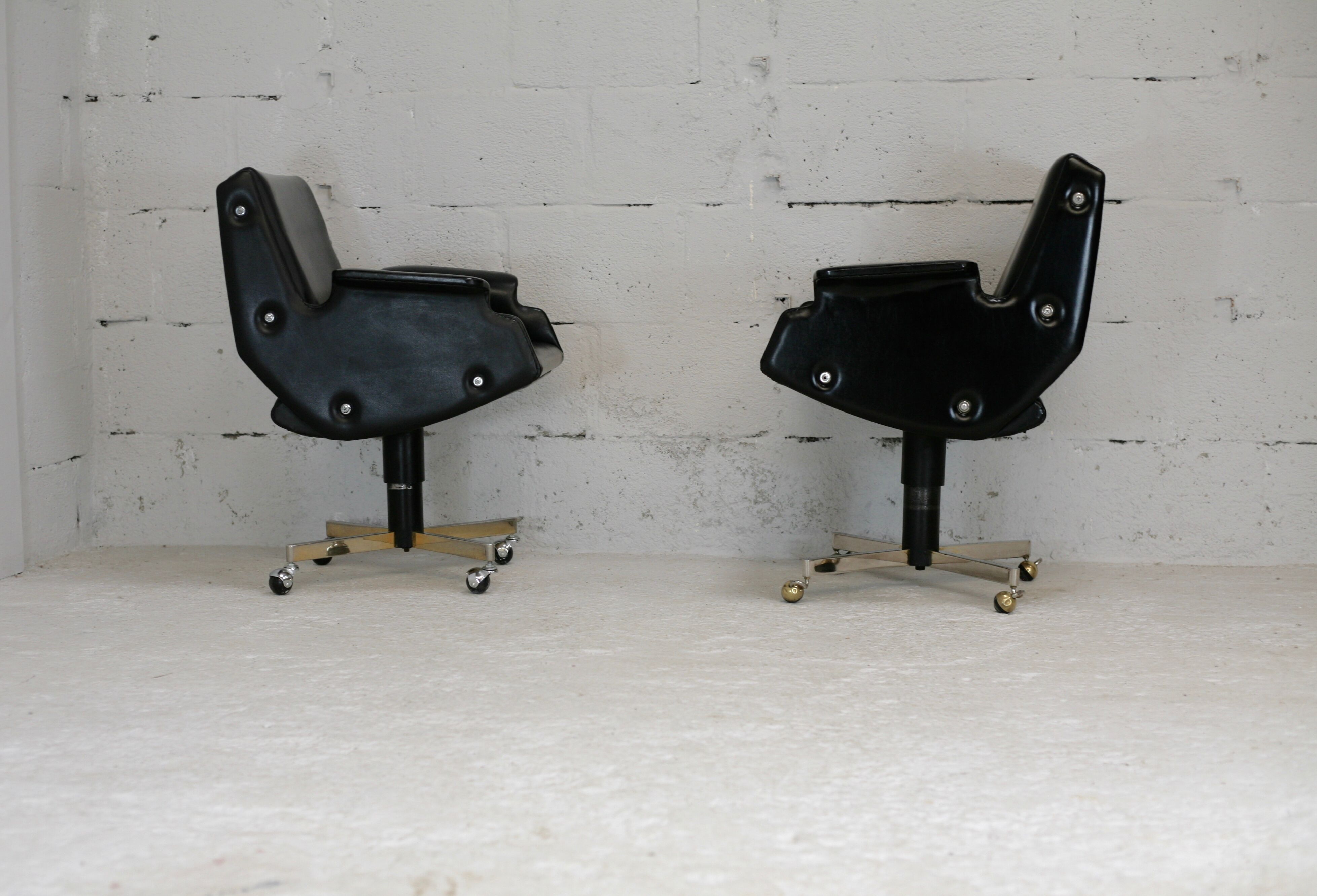 Pair of swivel armchairs, imitation leather and steel, Italy, circa 1960.