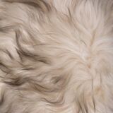 Danish Mid-century Modern stool reupholstered in white and black sheep skin