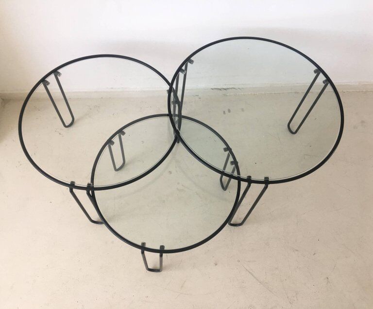 Set of three coffee tables black glass in the middle of the century with legs and metal hairpin