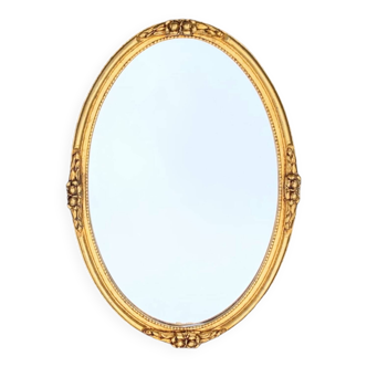 Old oval wall mirror in golden resin - 63 cm