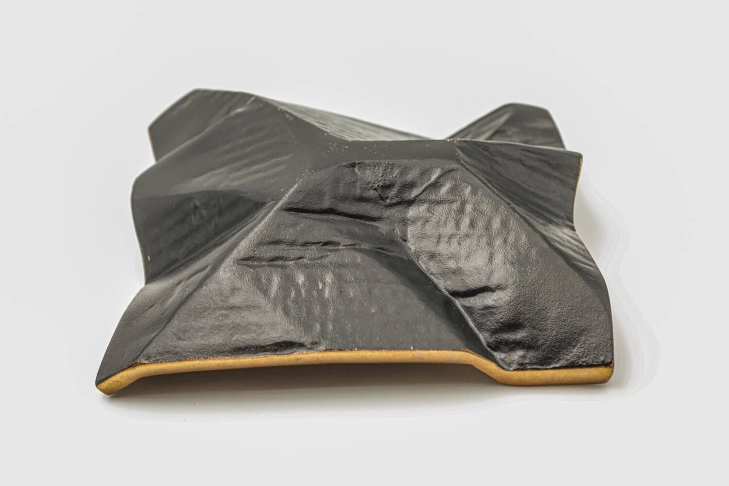 Brutalist bronze pocket emptier