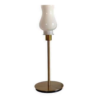 Table lamp with an old tulip lampshade in vintage white glass with a gold base